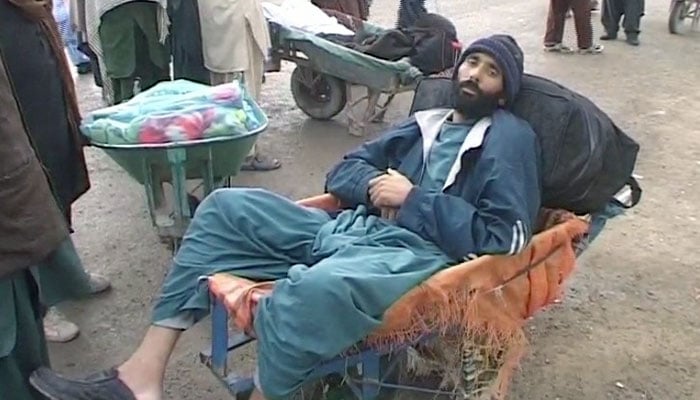 null A traveler rests at a wheel barrow after the Pak-Afghan border closes for traffic- Geo News