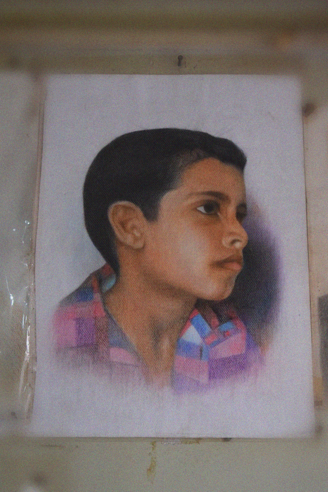 A sketched image of Muhammad Jawad Ahmed Jan by his father Jan Muhammed. The artwork is lined among numerous others in the shop in Lyari, Karachi, Pakistan. June 18, 2017. Image by author.