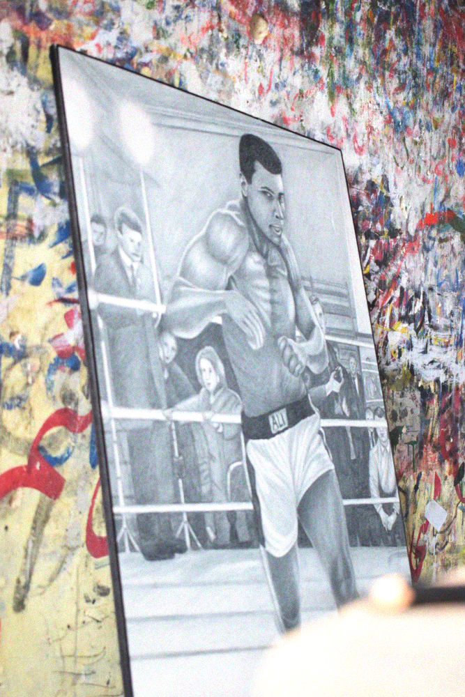 A sketched image of legendary boxer Muhammad Ali by Muhammad Jawad Ahmed Jan's father Jan Muhammed kept alongside numerous others in the shop in Lyari, Karachi, Pakistan. June 18, 2017. Image by author.