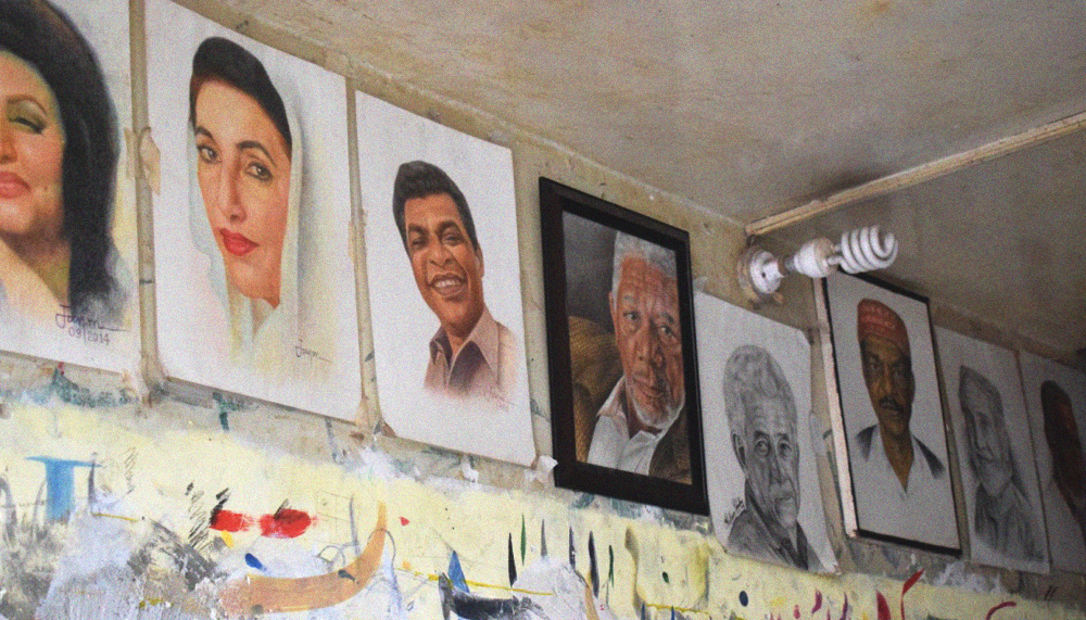 Some of Muhammad Jawad Ahmed Jan's artworks framed and displayed on the wall in his shop in Lyari, Karachi, Pakistan. June 18, 2017. Image by author.