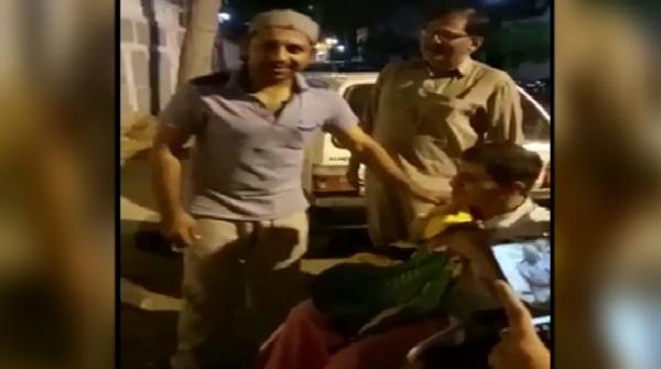 Sarfaraz gifts t-shirt to disabled fan outside house