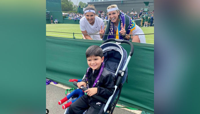 Sania Mirza and her doubles partner Bethanie Mattek-Sands pose with the Indian tennis stars son Izhaan Mirza after winning the Wimbledon&rsquo;s first round. Photo: Instagram/Sania Mirza