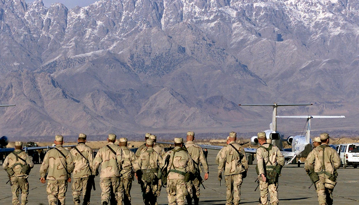 In this file photo taken on January 15, 2002, American soldiers approach the United Nations planes on the tarmac of the Bargam airbase in Bagram. All US and NATO troops have left Bagram Air Base, a US defence official told AFP Friday, signalling the complete withdrawal of foreign forces from Afghanistan was imminent. &mdash; AFP/File