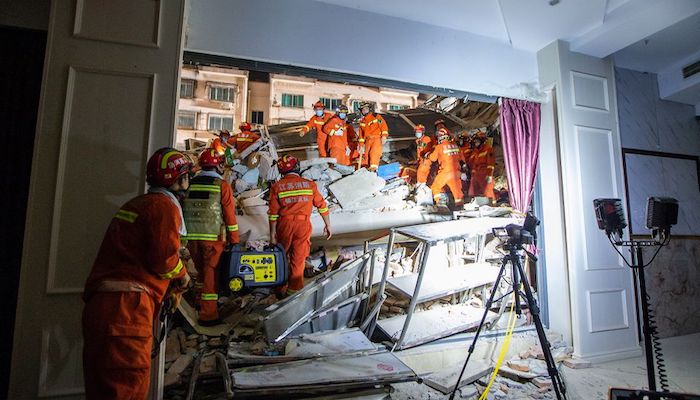 Rescue workers work at the site where a hotel building collapsed in Suzhou, Jiangsu province, China July 12, 2021. Picture taken July 12, 2021. China Daily via REUTERS
