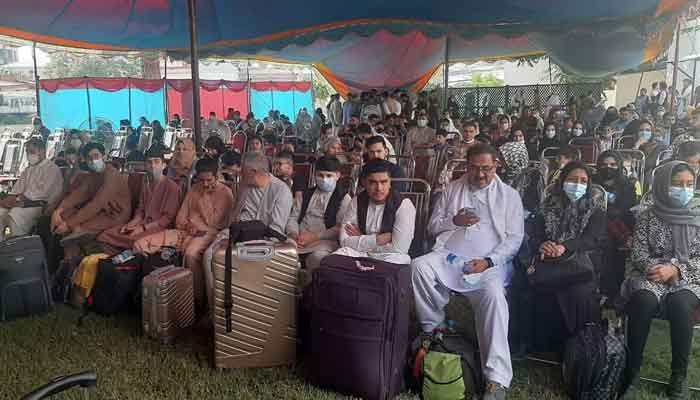 Passengers waiting at the compound of the Pakistan embassy before being transported under security to the Hamid Karzai International Airport for a PIA flight to Islamabad.