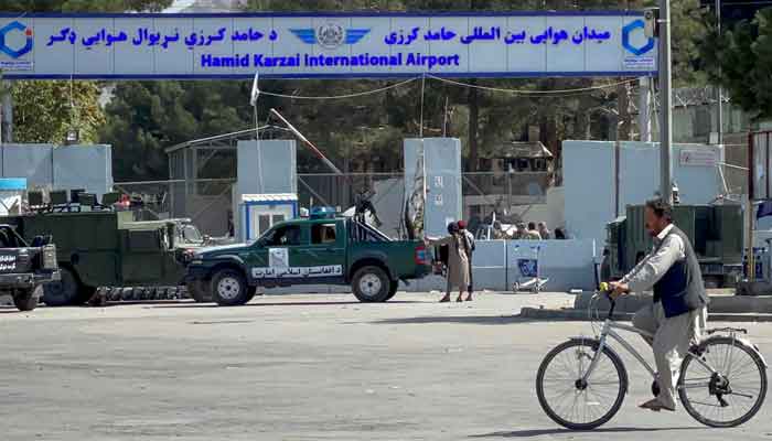 Taliban stand at the entrance gate of Hamid Karzai International airport while Taliban forces block the roads around the airport after yesterdays explosions in Kabul, Afghanistan August 27, 2021. &mdash; Reuters/Stringer