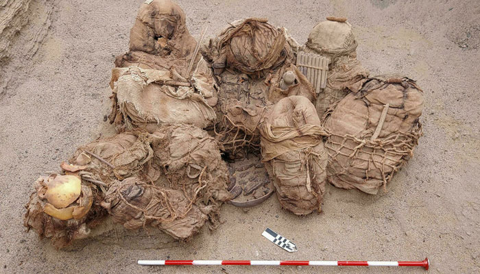 A handout picture released by Peruvian gas company Calidda shows objects, food, artefacts, and ancient funeral bundles containing the remains of eight people. AFP
