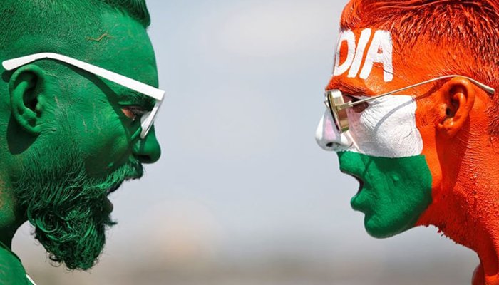 Cricket fans, with their faces painted in the Indian and Pakistani national flag colours, pose for a picture ahead of the first match between India and Pakistan in T20 World Cup super 12 stage in Dubai, in Ahmedabad, India. &mdash; Reuters/File