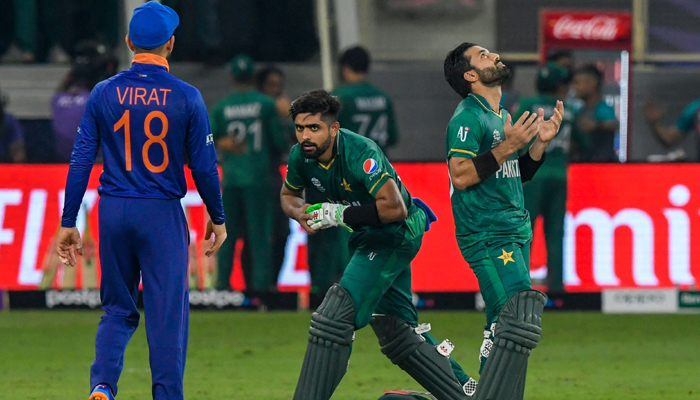 Pakistan´s team captain Babar Azam (C) and his teammate Mohammad Rizwan (L) react following their victory as India´s captain Virat Kohli looks on during the ICC menâ€™s Twenty20 World Cup cricket match between India and Pakistan at the Dubai International Cricket Stadium in Dubai on October 24, 2021. — AFP