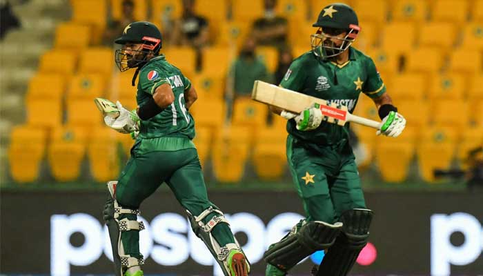 Pakistans wicketkeeper Mohammad Rizwan (L) and Babar Azam run between the wickets during the ICC Mens Twenty20 World Cup cricket match between Namibia and Pakistan at the Sheikh Zayed Cricket Stadium in Abu Dhabi on November 2, 2021. — Photo by INDRANIL MUKHERJEE/AFP
