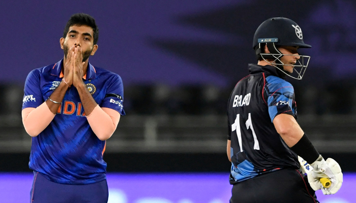 Indias Jasprit Bumrah (L) reacts next to Namibias Stephan Baard during the ICC menâ€™s Twenty20 World Cup cricket match between India and Namibia at the Dubai International Cricket Stadium in Dubai on November 8, 2021. — AFP