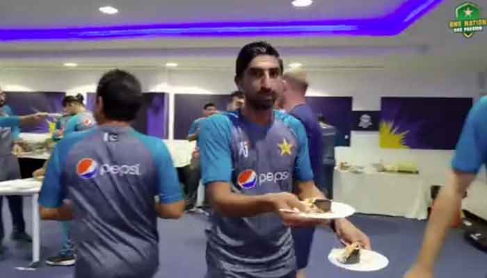 Fast bowler Shahnawaz Dahani hands out plates of cake to Scottish cricketers. Photo: PCB Twitter video screengrab