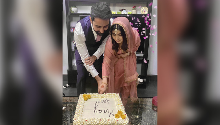 Asser Malik (left) and Malala Yousafzai cutting a cake together in Birmingham, United Kingdom. — Twitter