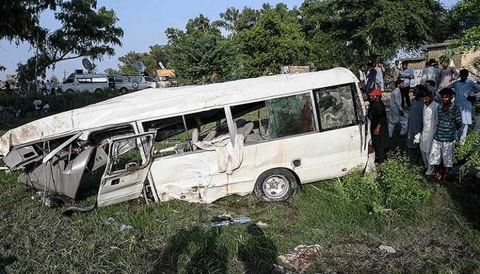 In this file photo, residents gather around the wreckage of a van alongside a railway track following the accident between a train and a van transporting Sikh pilgrims, in Punjab on July 3, 2020. Photo: AFP