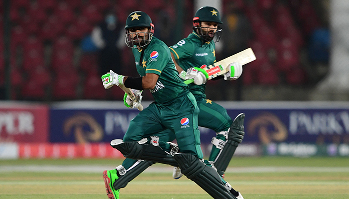 Pakistan&acute;s captain Babar Azam (L) and his teammate Mohammad Rizwan run between the wickets during the third Twenty20 international cricket match between Pakistan and West Indies at the National Stadium in Karachi on December 16, 2021. &mdash; AFP