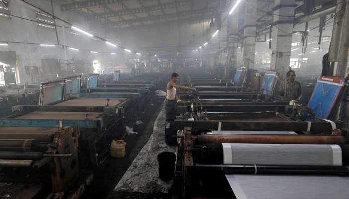 Labourers working at a textile factory. &mdash; Reuters/File