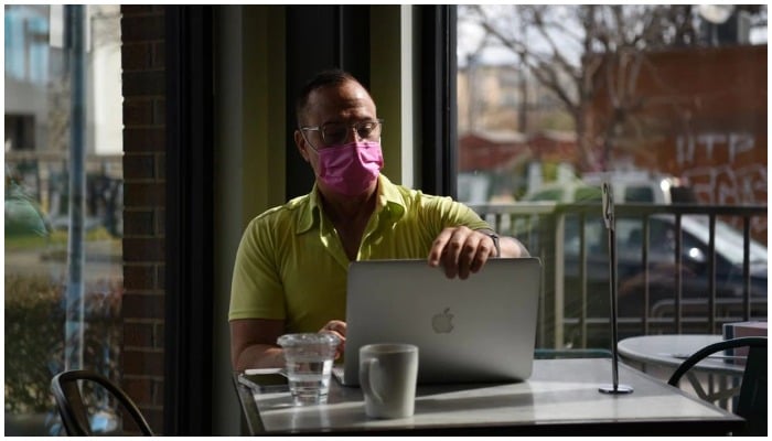 A man wearing a mask works on his laptop as the state of Texas prepares to lift its mask mandate and reopen businesses to full capacity during the coronavirus disease (COVID-19) pandemic in Houston, Texas, US, March 9, 2021. — Reuters/File