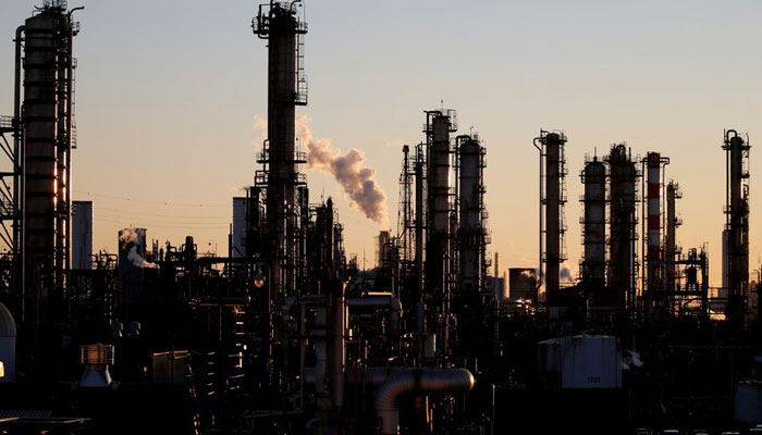 Smoke rises from a factory during the sunset. &mdash; Reuters/File