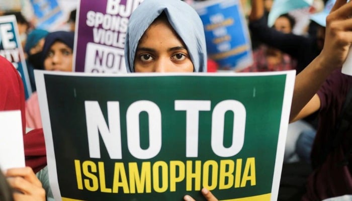 A citizen holds a placard during a peace vigil organised by citizens against what they say is rise in hate crimes and violence against Muslims in the country, in New Delhi, India, April 16, 2022. — Reuters/File