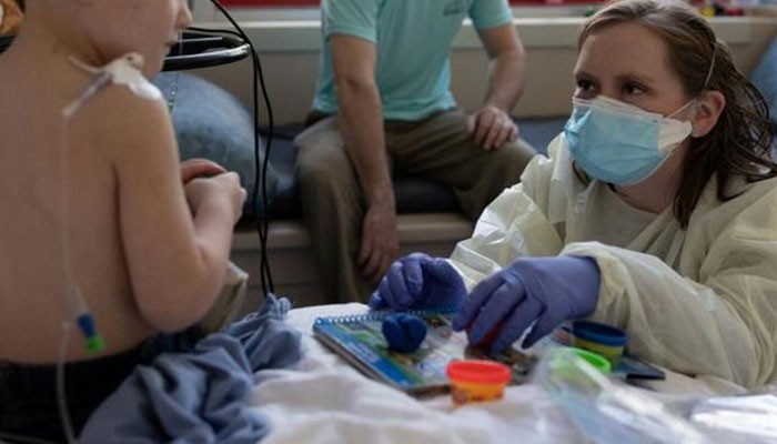 A healthcare worker taking care of a child suffering from hepatitis. — Reuters/File