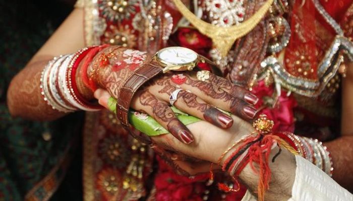Bride Kalpana, 22, and her groom Bhavin Munjpara, 26, lying in a bed, exchange wedding vows inside a hospital in Ahmedabad February 17, 2012. The couple took their wedding vows in a hospital after Munjpara fractured his feet in a road accident on February 11, their relatives said.—Reuters