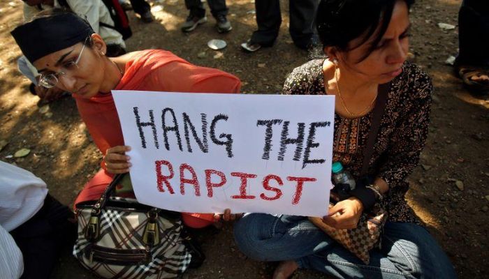 Protesters hold a sign as they participate in a demonstration to mourn the death of a rape victim, who was assaulted in New Delhi, in Mumbai, on December 29, 2012. — Reuters