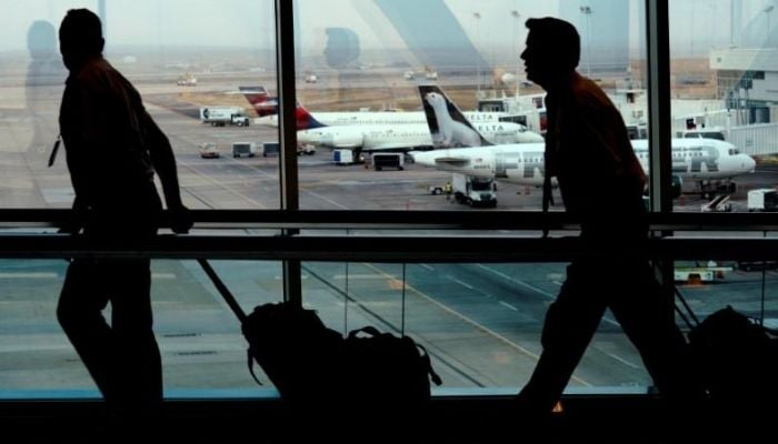 A flight crew walks through Denver International Airport in Denver, Colorado, U.S. November 3, 2017.