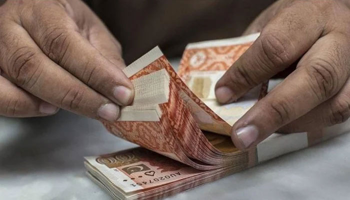 A currency dealer is counting Rs5,000 notes. &mdash; AFP/File
