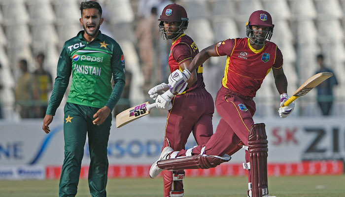 Shamarh Brooks (R) and Shai Hope (C) run between the wicket as Hasan Ali watches during the first ODI between Pakistan and West Indies at the Multan Cricket Stadium. &mdash; AFP