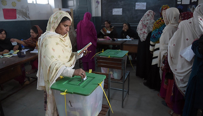 A voter casts her ballot at a polling station in Islamabad, on November 30, 2015. &mdash; AFP