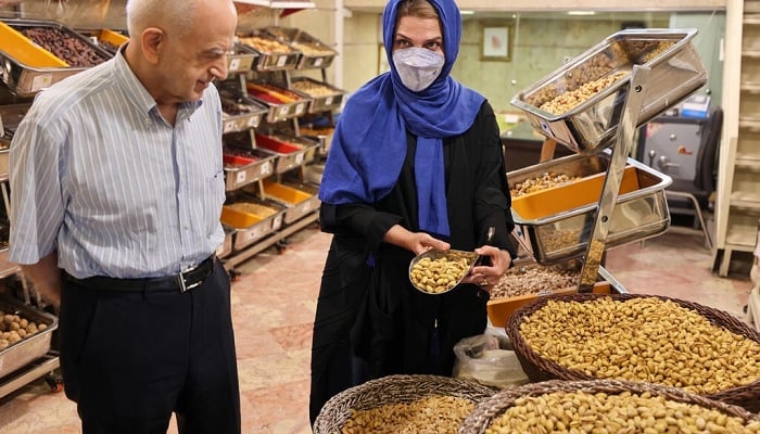 Iranian pistachio wholesaler Abbas Emami and his daughter Marjan.&mdash;AFP