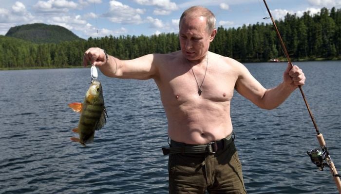 Russian President Vladimir Putin holds a fish he caught during the hunting and fishing trip which took place on August 1-3 in the republic of Tyva in southern Siberia, Russia, in this photo released by the Kremlin on August 5, 2017. &mdash; Reuters