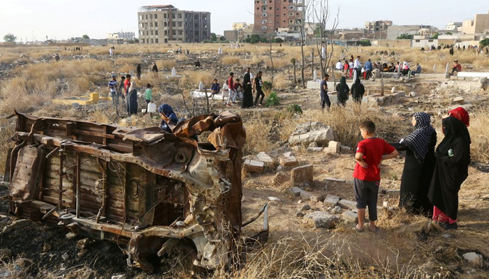 People visit the graves of their loved ones during the first day of the Muslim holiday of Eid-ul-Fitr in Raqqa, Syria, on June 5, 2019. &mdash; Reuters