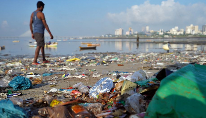 A man walks on a garbage-strewn beach in Mumbai, India, October 2, 2019.&mdash;Reuters