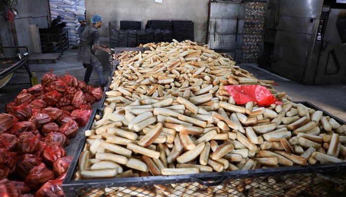 A worker moves bread molds at a bakery in Sanaa, Yemen March 1, 2022. Picture taken March 1, 2022. &mdash; Reuters