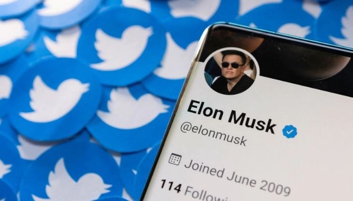 Elon Musks Twitter profile is seen on a smartphone placed on printed Twitter logos in this picture illustration taken April 28, 2022.&mdash; Reuters
