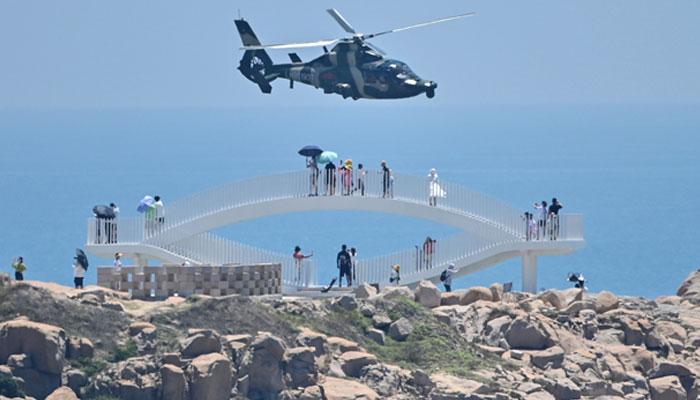 Chinese military helicopters fly past Pingtan island, one of mainland China&rsquo;s closest points to Taiwan, in Fujian province on August 4, 2022. &mdash; AFP