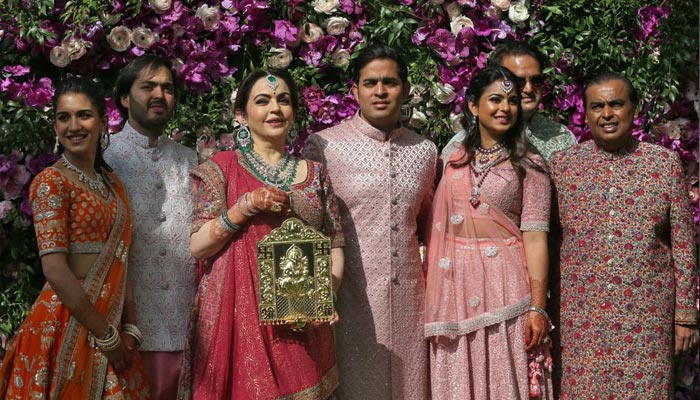 (L-R) Radhika Merchant, Anant Ambani, Nita Ambani, Akash Ambani, Isha Piramal, Anand Piramal and Mukesh Ambani, the Chairman of Reliance Industries, pose during a photo opportunity at the wedding ceremony of Akash, at Bandra-Kurla Complex in Mumbai, India, March 9, 2019. &mdash; Reuters/File