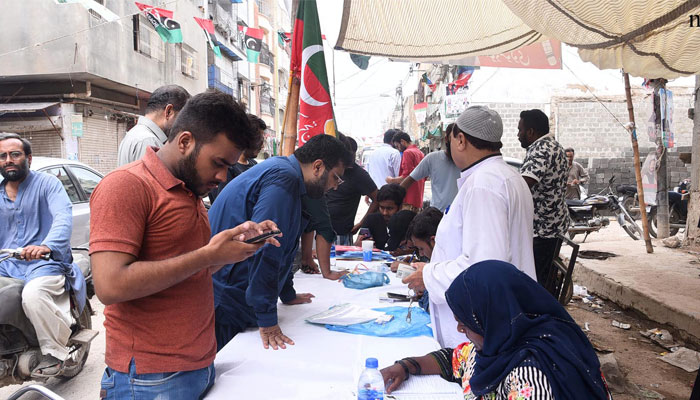 A voter at a PTI camp outside a polling station during the NA-245 by-poll. &mdash; NNI