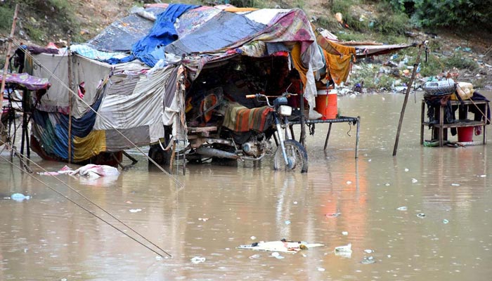 A view of huts submerged in the rainwater near a new bus stand after heavy rain in the city. &mdash; APP/File