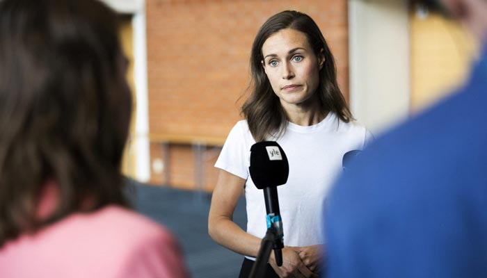 Finlands Prime Minister Sanna Marin speaks with members of the media in Kuopio, Finland, on August 18, 2022. &mdash; Reuters/File