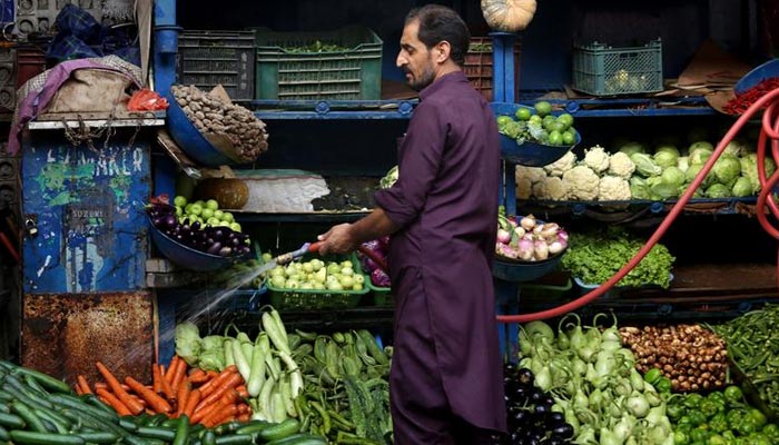 A vendor waters the vegetables at a stall in Islamabad, Pakistan July 4, 2019. &mdash; Reuters/File