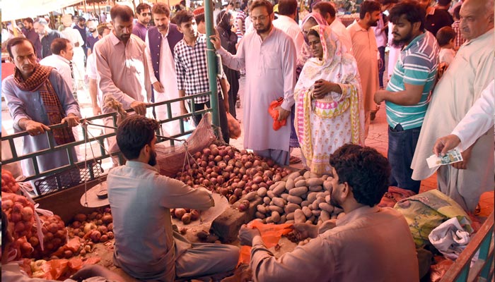 People are busy is buying vegetables from a vendor at Sunday weekly bazaar in Federal Capital, as prices of various vegetables and fruits have massively surged in Punjab and other parts of the province and they are expected to increase further in the coming days due to short supply in markets and destruction of the crops by the floods in Balochistan and Sindh. &mdash; Online/File