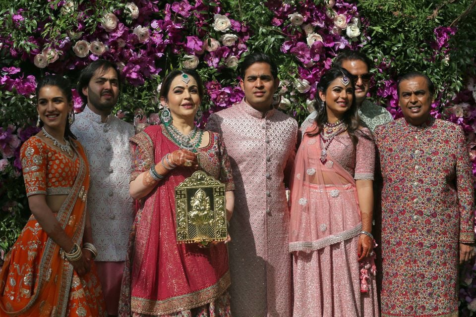 (L-R) Radhika Merchant, Anant Ambani, Nita Ambani, Akash Ambani, Isha Piramal, Anand Piramal and Mukesh Ambani, the Chairman of Reliance Industries, pose during a photo opportunity at the wedding ceremony of Akash, at Bandra-Kurla Complex in Mumbai, India, March 9, 2019. &mdash; Reuters