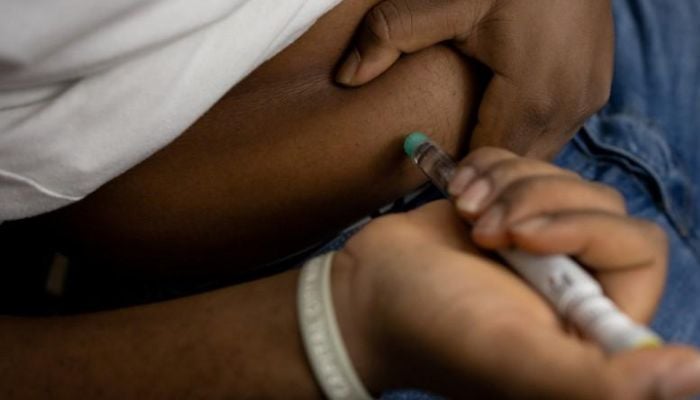 Type 2 diabetes patient gives himself insulin shot. &mdash; Reuters