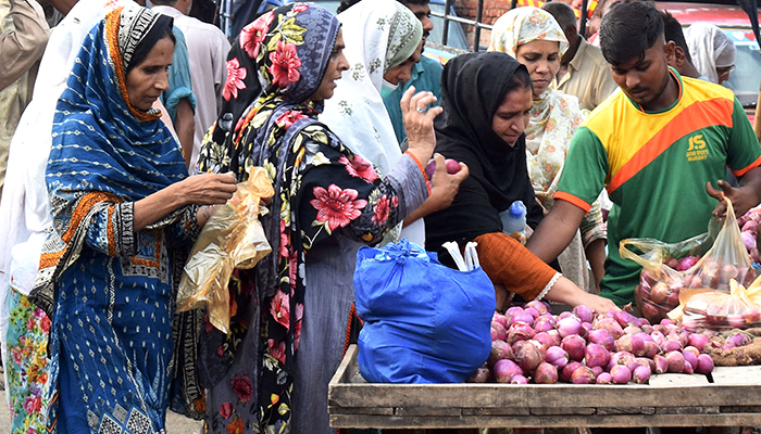 Women purchase onions at a vegetable Market in Lahore, Punjab, on August 31, 2022. &mdash; Online