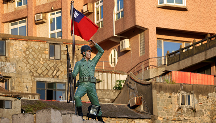 A Taiwan flag flutters behind a soldier statue on Dongyin island of Matsu archipelago in Taiwan August 15, 2022. &mdash; Reuters