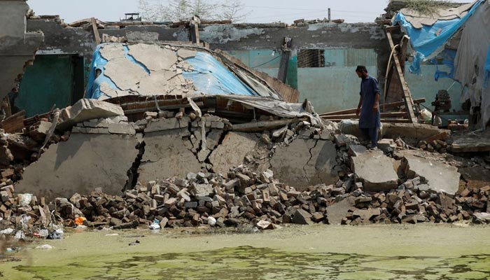 A man surveys the damage caused to his house following rains and floods during the monsoon season, in Charsadda, Pakistan September 3, 2022. &mdash; Reuters