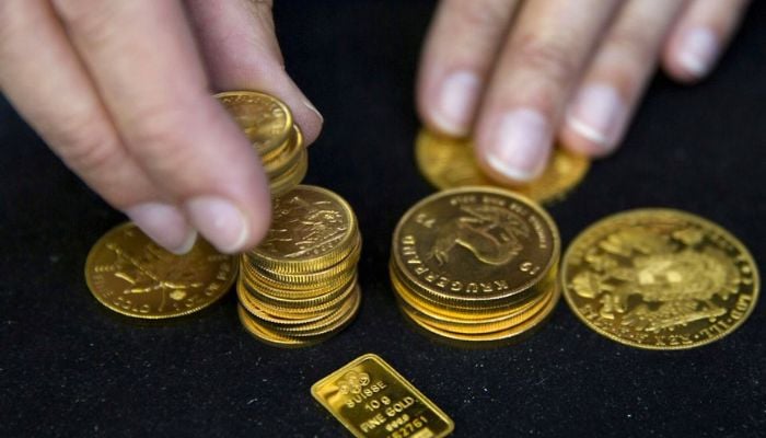 A worker places gold bullion on display at Hatton Garden Metals precious metal dealers in London, Britain July 21, 2015. &mdash; Reuters