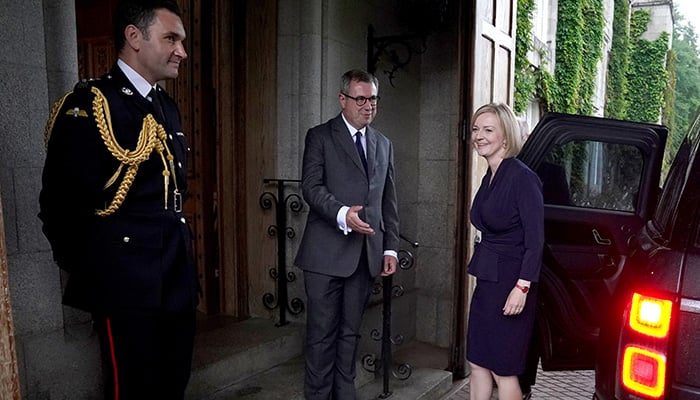 Newly elected leader of the Conservative party Liz Truss is greeted by Britains Queen Elizabeths Equerry Lieutenant Colonel Tom White and her Private Secretary Sir Edward Young as she arrives for an audience with Queen Elizabeth where she will be invited to become Prime Minister and form a new government, at Balmoral Castle, Scotland, Britain September 6, 2022. &mdash; Reuters